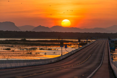 Panoramic view of railroad track against sky during sunset