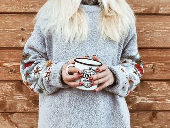 Midsection of woman holding camera