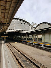 Train at railroad station against sky