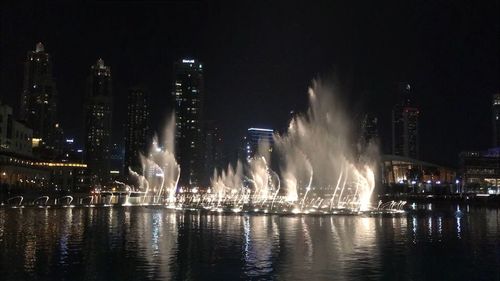 Fountain in city at night