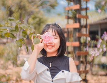 Portrait of smiling girl holding flower