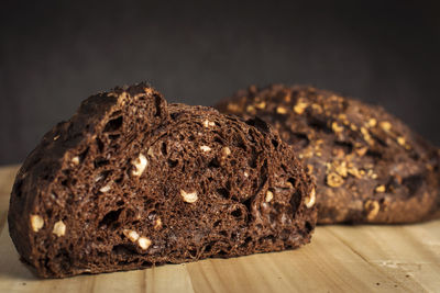 Close-up of bread on table against black background