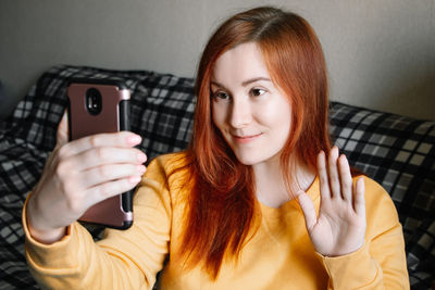 Portrait of young woman using mobile phone