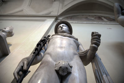 Low angle view of statue against ceiling