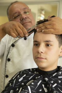 Portrait of teenage boy holding camera