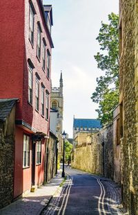 Empty alley amidst buildings in city