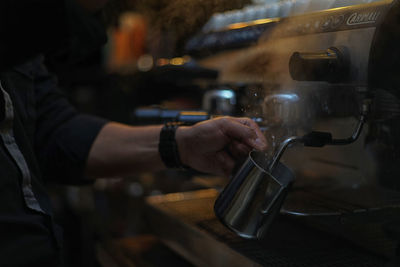 Midsection of man having coffee