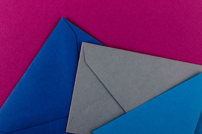 High angle view of multi colored paper against blue background