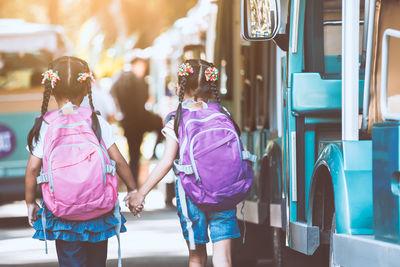 Rear view of women walking outdoors