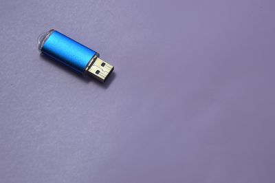 High angle view of usb stick on blue background