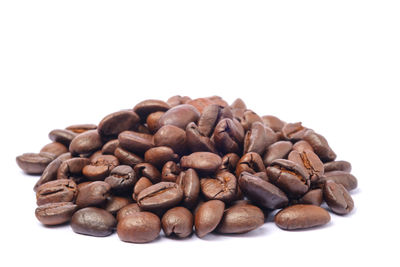 Close-up of coffee beans against white background