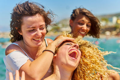 Close-up of cheerful female friends on sunny day