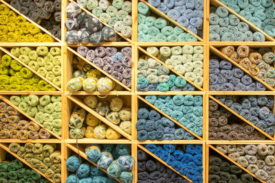 Full frame shot of multi colored wool on shelves