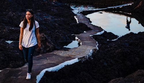 Woman walking on footpath