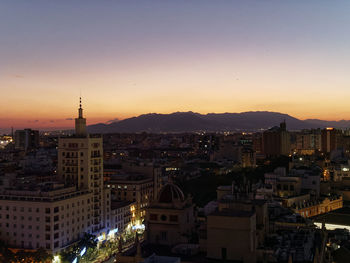 High angle view of city buildings during sunset