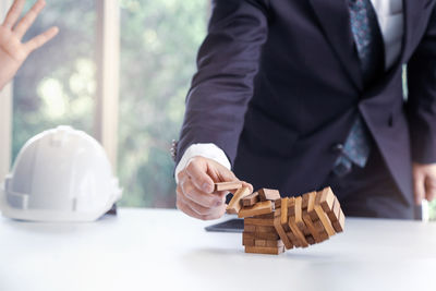 Midsection of man playing with table