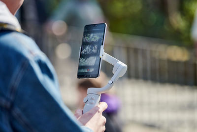 Midsection of man using mobile phone