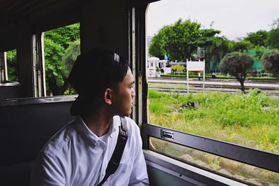 Boy looking through window