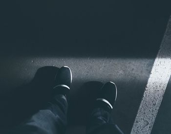 Low section of man standing on floor