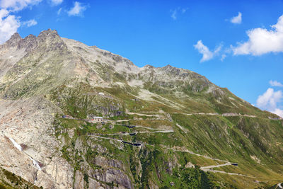 Scenic view of mountains against blue sky