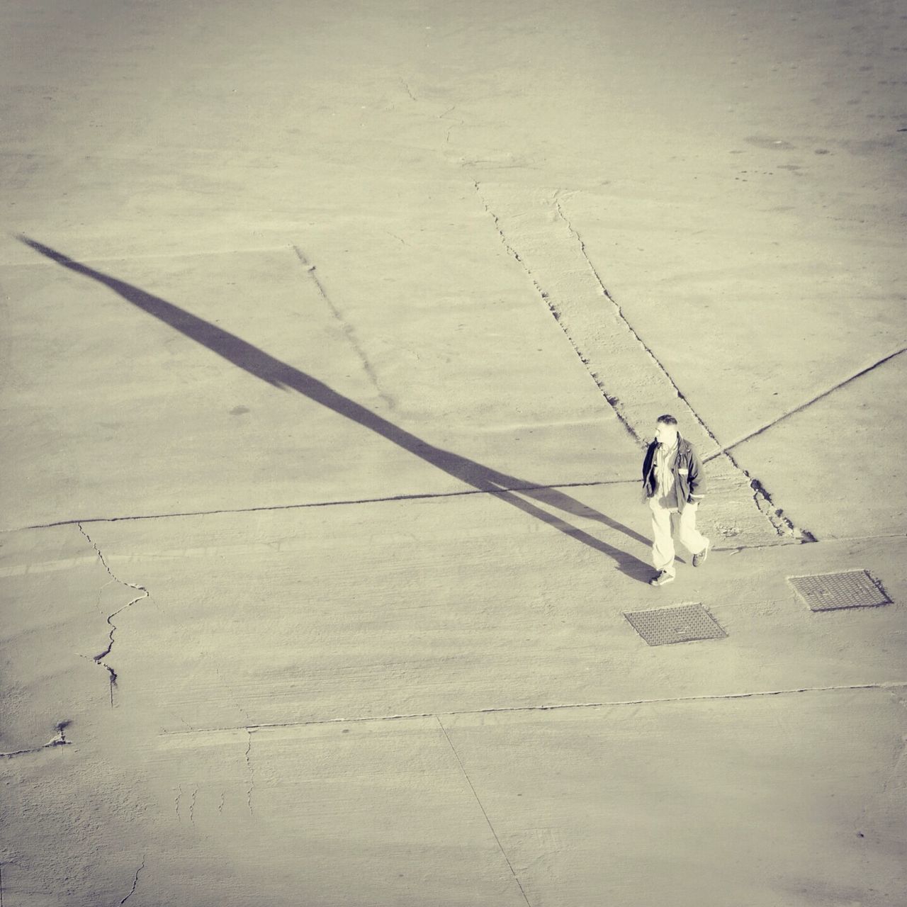 lifestyles, leisure activity, men, high angle view, walking, shadow, full length, person, day, outdoors, sunlight, sport, wall - building feature, unrecognizable person, sand, childhood, transportation