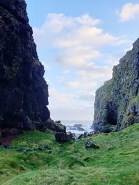 Scenic view of rocks and sea against sky