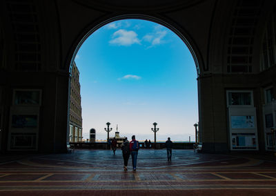 Tourists walking towards sea