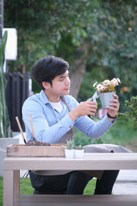 Young man sitting on table