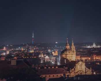 Illuminated buildings in city against sky