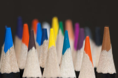 Close-up of colored pencils over white background