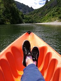 Low section of person on boat in river