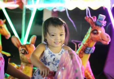 Happy kid portrait of smiling girl playing at playground