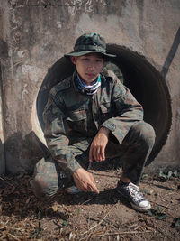 Portrait of boy sitting in container