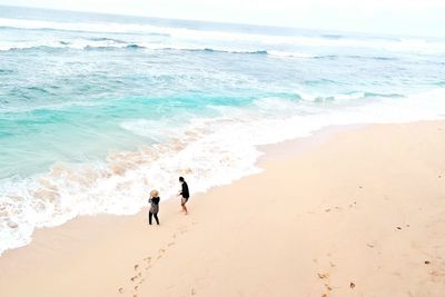 People on beach against sky
