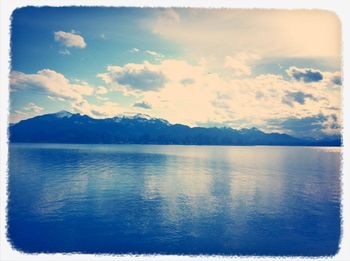 Scenic view of lake against cloudy sky