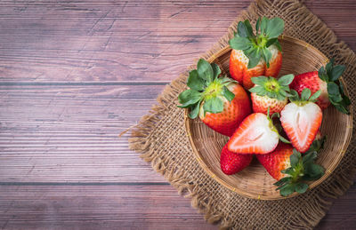 High angle view of strawberries in basket on table