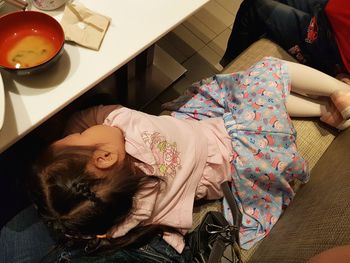 High angle view of girl lying on bed at home