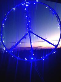 Low angle view of illuminated ferris wheel