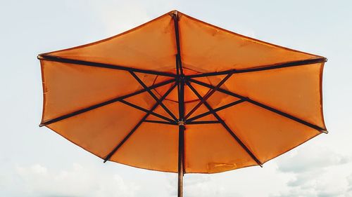 Low angle view of umbrella against sky