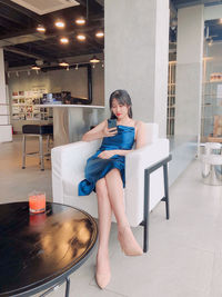 Full length of woman sitting on chair