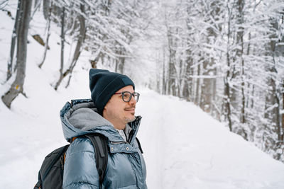 Portrait of man on road in winter forest
