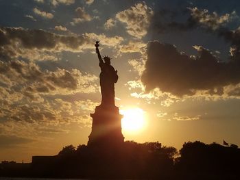 Low angle view of statue at sunset