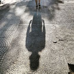 Low section of man shadow on ground