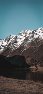 Scenic view of snowcapped mountains against clear sky