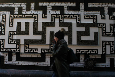 Woman standing against wall