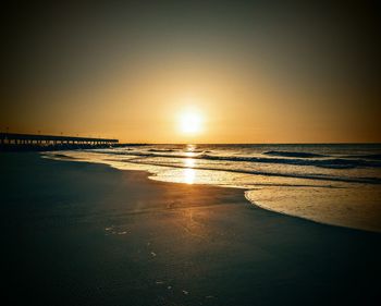 Scenic view of beach against sky during sunset