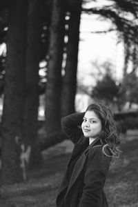 Portrait of smiling young woman standing on land