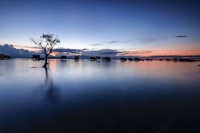 Scenic view of lake at sunset