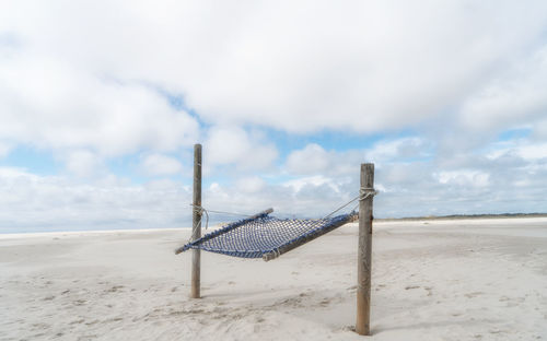 Lifeguard hut on beach against sky