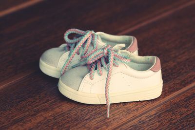 Close-up of shoes on wooden table